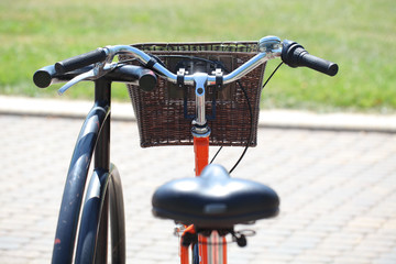road bike with a wicker basket of orange on the steering wheel