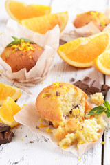 Tasty cupcakes with orange on table close-up
