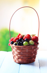 Forest berries in wicker basket,