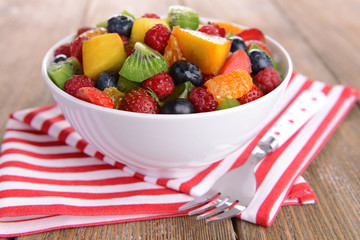 Delicious fruits salad in plate on table close-up