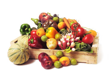crates of fruit and vegetables on white background in studio.
