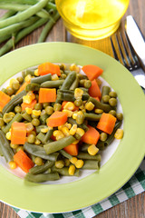 Delicious vegetables salad on plate on table close-up