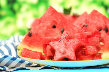 Fresh slices of watermelon on table, outdoors