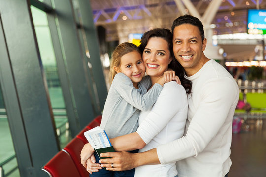 caucasian family looking at the camera at airport
