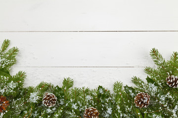 Christmas decoration on the wooden white background with snow or