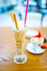 Iced coffee, frappe, with whipped cream, almonds cream