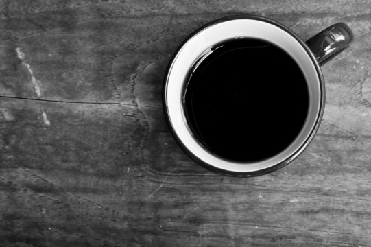 Cup of black coffee  on wooden background.Black and white