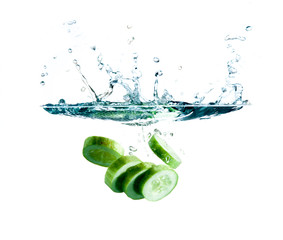 sliced cucumber splashing water isolated on white background