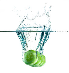 sliced cucumber splashing water isolated on white background