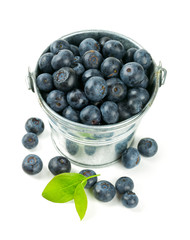 fresh blueberries in a bucket over white