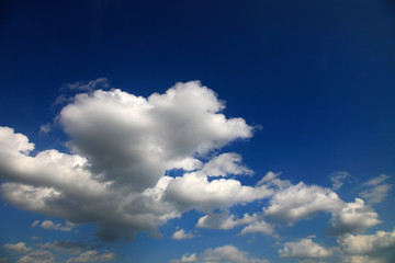 Blue sky with white cumulus clouds.
