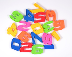 Fototapeta premium Colorful plastic numbers on a white
