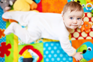 Infant boy on playmat