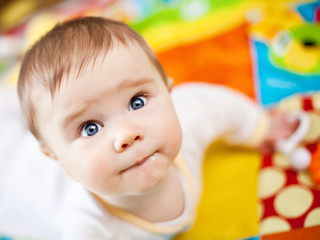 Infant boy on playmat