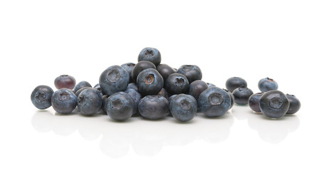 ripe blueberries on a white background with reflection