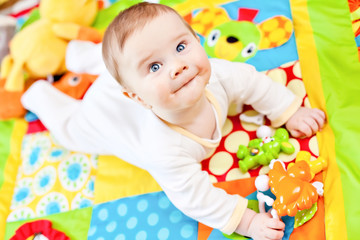 Fototapeta na wymiar Infant boy on playmat