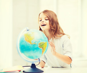 student girl with globe at school
