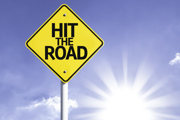 Hit The Road road sign with sun background