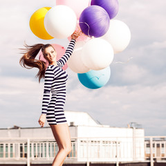 beautiful lady in short black and white striped dress holds bunc