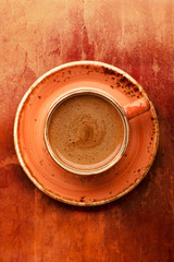 Cup of coffee on textured background