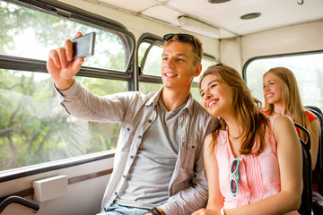 smiling couple with smartphone making selfie