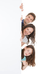 Confident Family Holding Blank Billboard