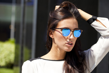 Fototapeta na wymiar Business woman with blue mirrored sunglasses