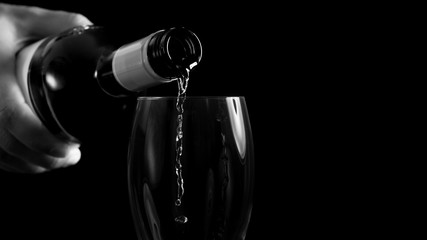 Man pouring white wine into a glass