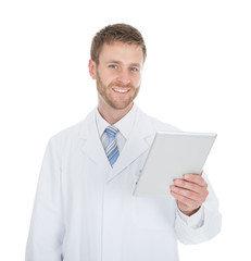 Smiling Male Doctor Using Digital Tablet