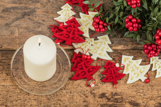noel decoration and candle on wooden surface