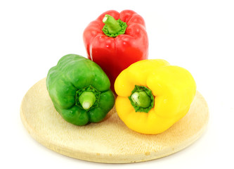sweet pepper and  chopping block on white background