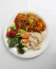 A vegetarian dinner on a white plate, isolated on white