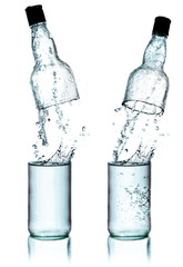 Fresh water splashing out of bottle, isolated on white backgroun