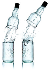 Fresh water splashing out of bottle, isolated on white backgroun