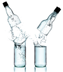 Fresh water splashing out of bottle, isolated on white backgroun