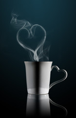White cup of coffee with a dense smoke 