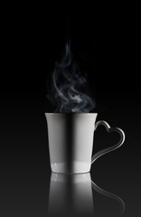 White cup of coffee with a dense smoke 