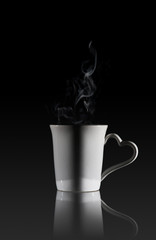 White cup of coffee with a dense smoke 