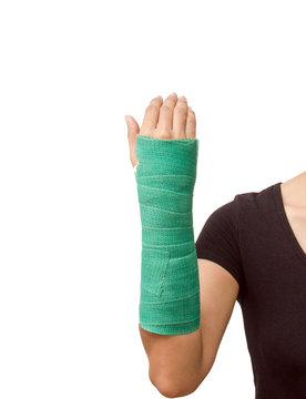 broken arm with green cast on white background