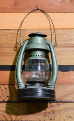 Old lantern and saw hanging on a shed.