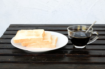 plate with a cup of coffee and bread