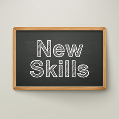 new skills on blackboard in wooden frame
