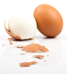 peeled boiled egg on white background