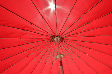 red umbrella underside in summer time