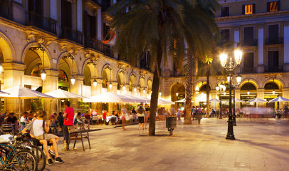 night view of Placa Reial with restaurants - obrazy, fototapety, plakaty