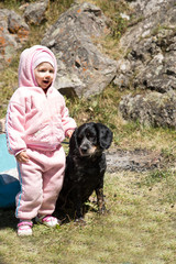 Adorable little child girl playing with pet dog outdoor