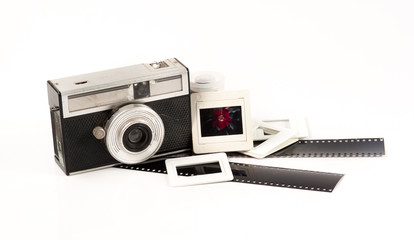 old camera and blank film strip on White background