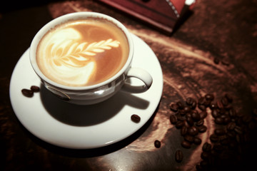 White cup of coffee with beans
