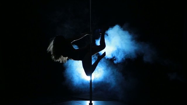 3of23 Silhouette of a sexy female pole dancing