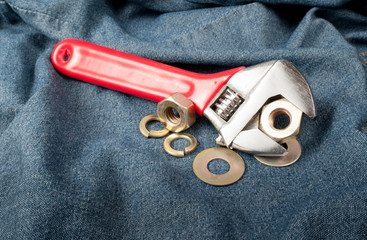 closeup of an adjustable wrench on jean
